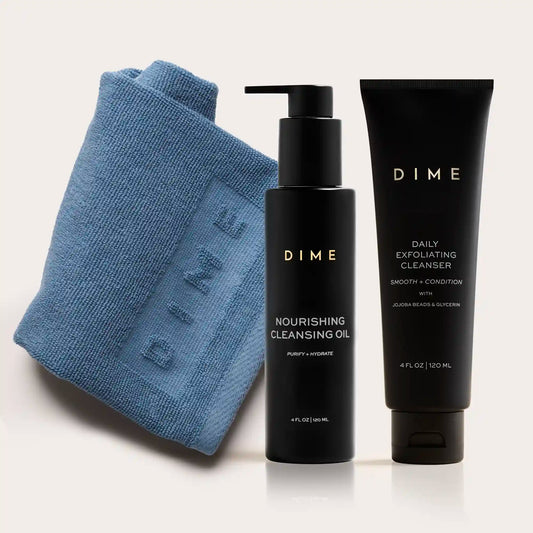 Blue textured cleansing cloth with black pump bottle of nourishing cleansing oil and black tube of daily exfoliating cleanser