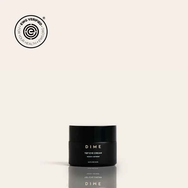 Black jar labeled "DIME TBT Eye Cream" with EWG Verified seal displayed above on beige background.