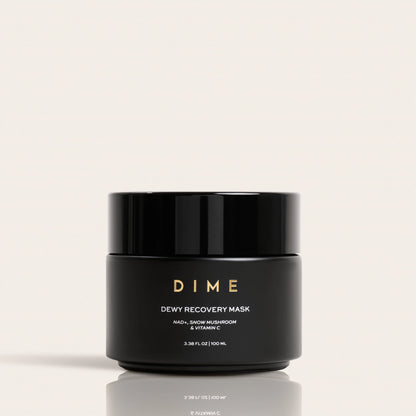 Black jar labeled "DIME Dewy Recovery Mask" with gold text, 3.38 fl oz size, on neutral background.