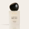 Cream-colored perfume bottle with black spherical cap labeled "I Love Your Smell, Baby" eau de parfum spray, 1.7 fl oz.