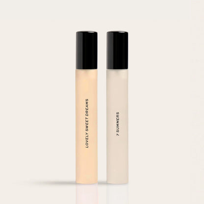 Two cylindrical fragrance bottles with black caps labeled "Lovely Sweet Dreams" and "7 Summers" in peach and cream liquid res